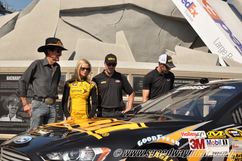 Petty Clan looking at the car with Miss Sprint Cup Kim.jpg